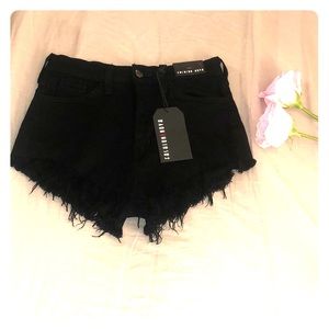 Black Fashion Nova ripped denim shorts tags on